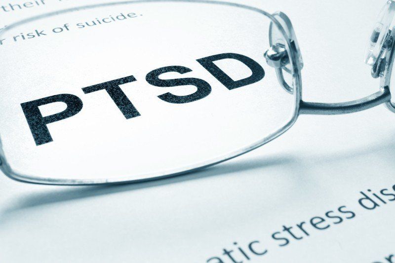 A pair of glasses with the word ptsd on them